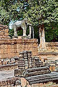 Angkor - Eastern Mebon - monolithic elephants at the corners of the platforms of the pyramid